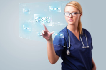 Young nurse pressing modern medical type of buttons