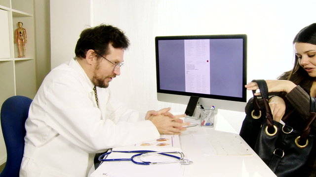 Doctor giving good news to happy female patient