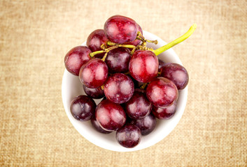 Grapes in bowl on hessian burlap background