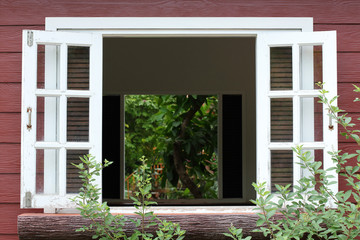 Fototapeta na wymiar white wood window on wooden house