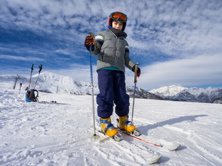 Skiing, portrait of young kid skier on ski slope