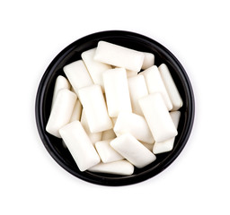 Bowl with pieces of tasty white chewing gum