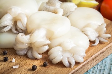Raw babies cuttlefish  on a cutting board closeup