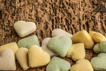 heart shaped candies on wooden surface