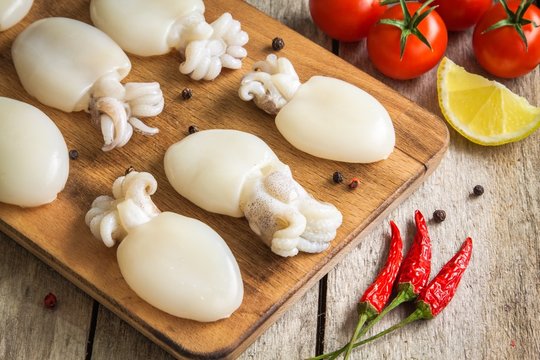 Raw babies cuttlefish  on rustic background