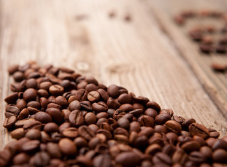 coffee beans and cup on wooden background