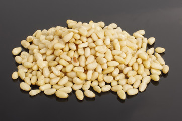 Heap of pine nuts isolated on the dark background