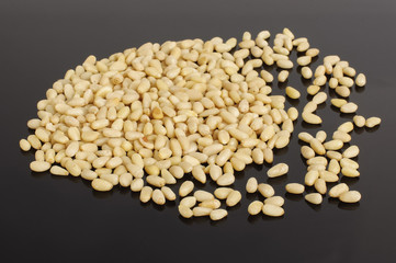 Many pine nuts isolated on the dark background