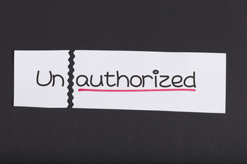Sign with word unauthorized turned into authorized
