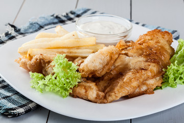 Fish and chips with tartar sauce on a plate