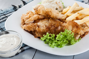 Fish and chips with tartar sauce on a plate