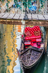 Fototapeta na wymiar Luxury gondola under bridge on water canal in Venice, Italy