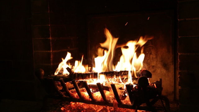 Bright flame of fire burns in an old fireplace