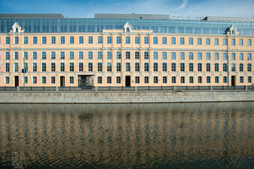 Long yellow business bulding on a river