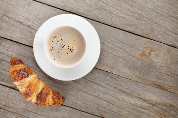 Cup of coffee and fresh croissant