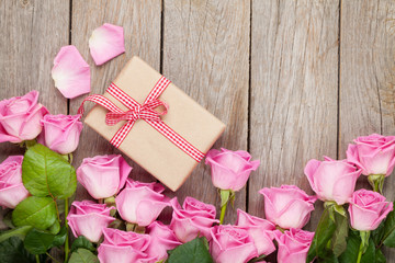 Valentines day background with pink roses over wooden table and