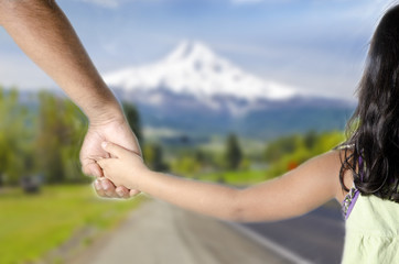 A little girl hoding hands of her daddy and walking