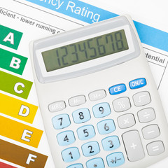 Calculator over energy efficiency chart - studio shot