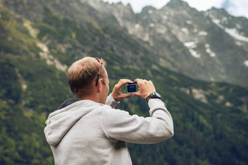Man make a photo of mountain landscape