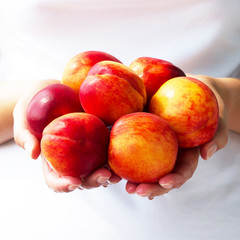 Juicy, ripe peaches in the hands