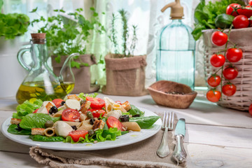 Spring salad in a sunny kitchen full of vegetables