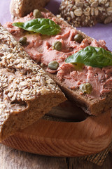 Sandwich with pate, capers and basil close-up vertical
