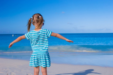 Adorable little girl at white beach during summer vacation