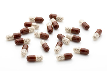 Antibiotic capsules on a white background.