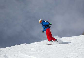 Snowboarder in high mountains