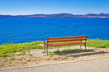 Naklejka na ściany i meble Empty bench by the sea