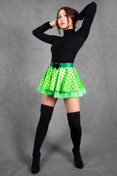 Portrait of a young attractive woman in a bright green skirt