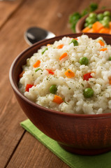 bowl full of rice on wood