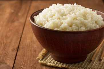 bowl full of rice on wood