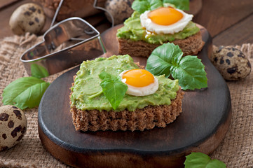 Sandwich with avocado paste and egg in the shape of heart