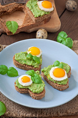 Sandwich with avocado paste and egg in the shape of heart