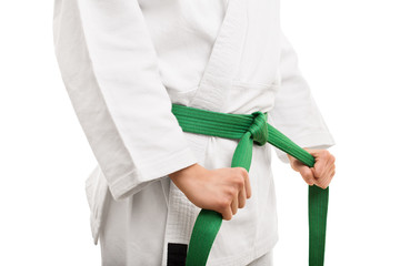 Young girl tying her karate belt - obrazy, fototapety, plakaty