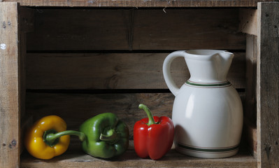bodegon with a pitcher and three peppers