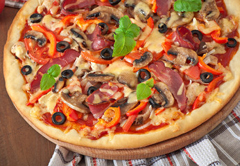 Pizza with ham, mushrooms and olives