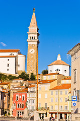 Fototapeta premium Bell tower and buildings at Tartini square in Piran, Istria