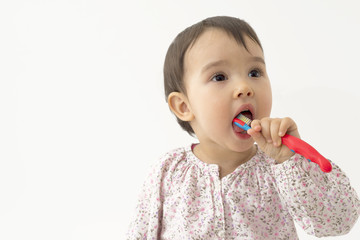 little girl brushing her teeth