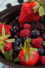 Rustic bowl with fresh summer berries fruits