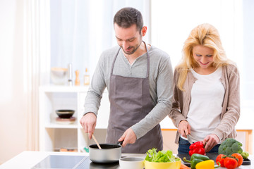Young attractive couple cooking in a kitchen