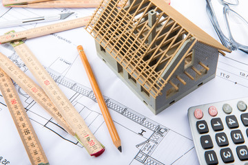 House miniature under construction on an architect desk