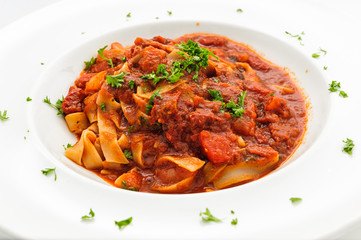 Steweb beef with noodle on white plate