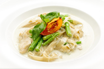 Stewed chicken with noodles on white plate