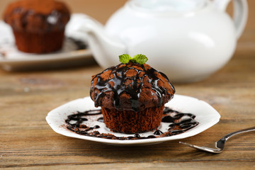 Yummy chocolate cupcake on table
