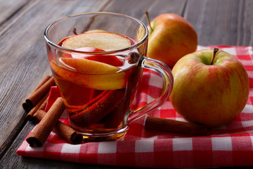 Apple cider with cinnamon sticks and fresh apples
