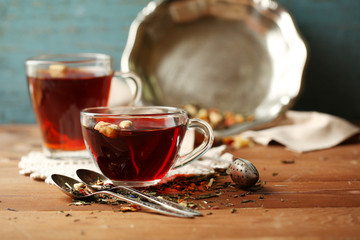 Beautiful vintage composition with herbal tea, on wooden table