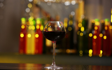 Glass of red wine in bar on blurred background