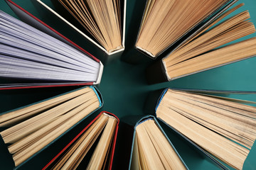 Group of books on colorful background, top view
